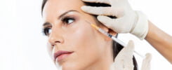 beautiful young woman getting botox cosmetic injection her face
